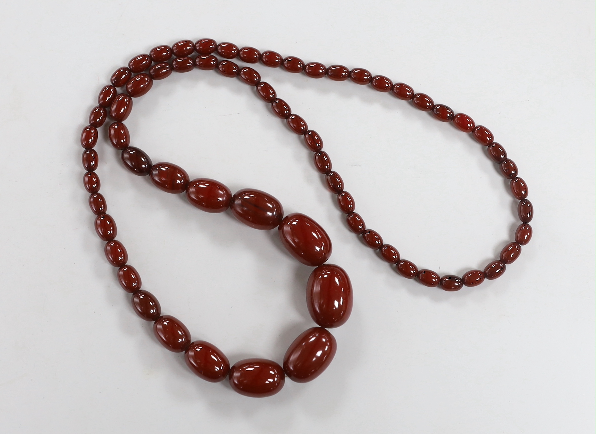 A single strand graduated cherry amber bead necklace, 82cm, 83 grams.